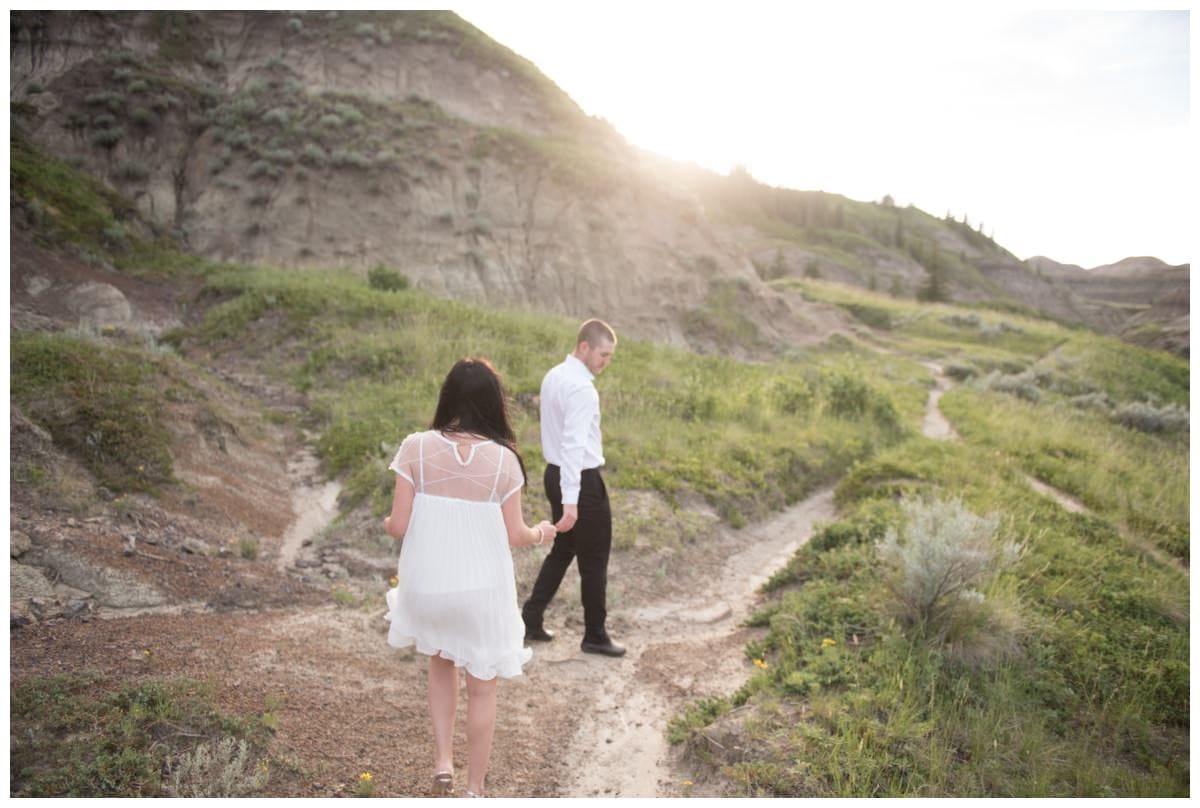 Beautiful couple walking through green valley Horseshoe Canyon Drumheller