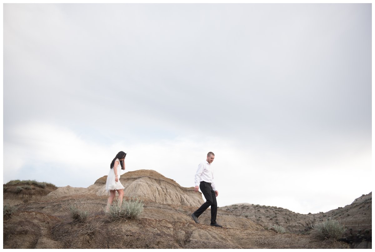 Couple walking along hoodoos at Horseshoe Canyon