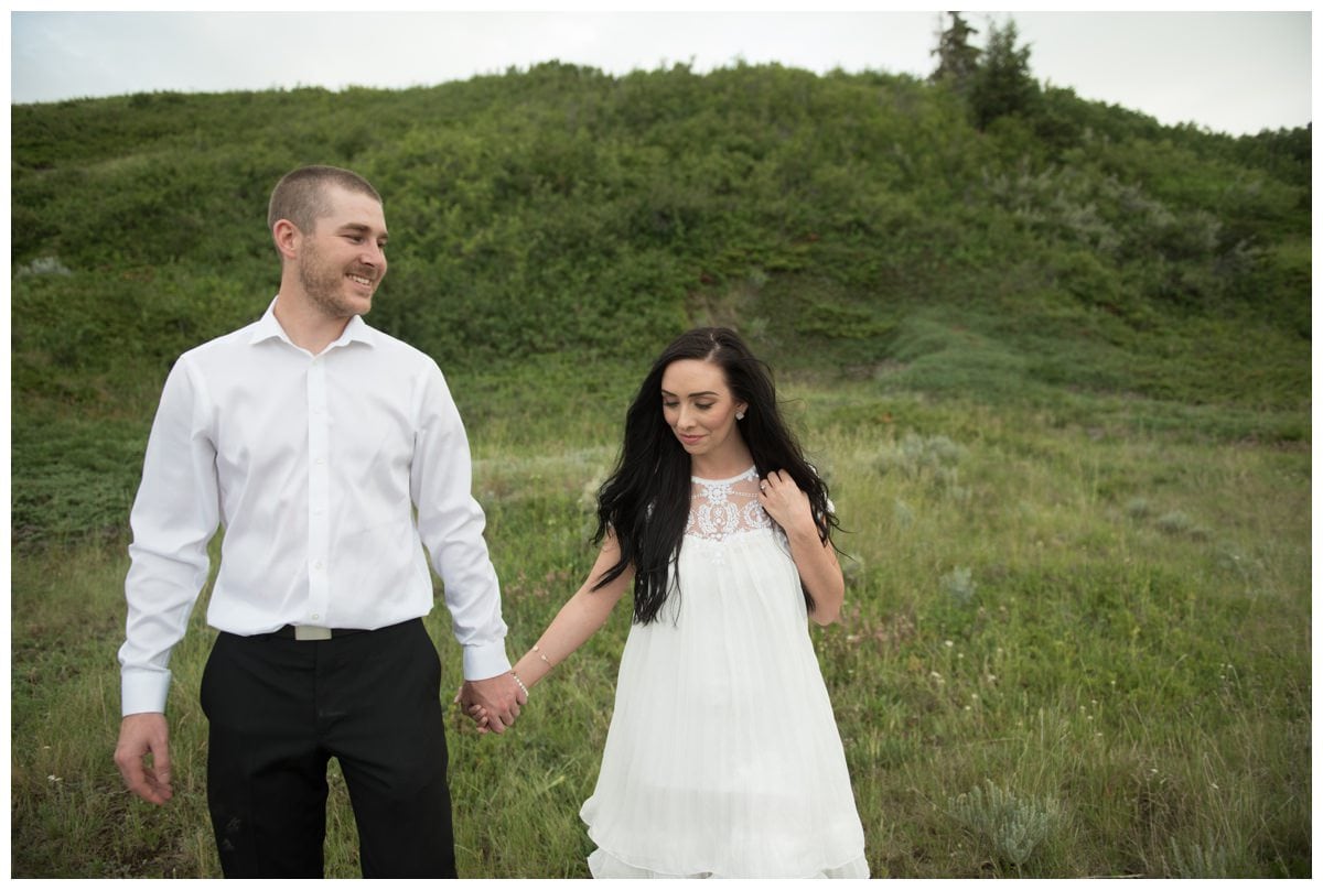 Beautiful couple walking through green valley Horseshoe Canyon Drumheller