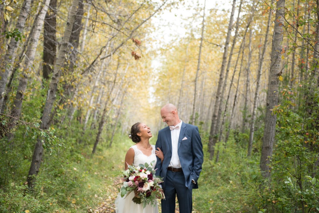 a year in review bride and groom laugh in yellow trees