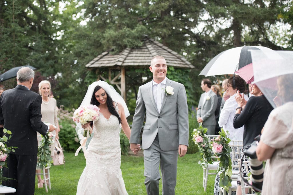 a year in review bride and groom walk down aisle after ceremony