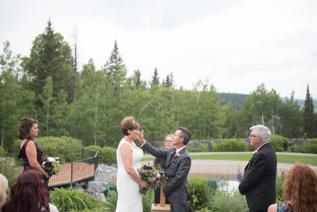 a year in review groom wipes tear from brides eye at azureridge wedding