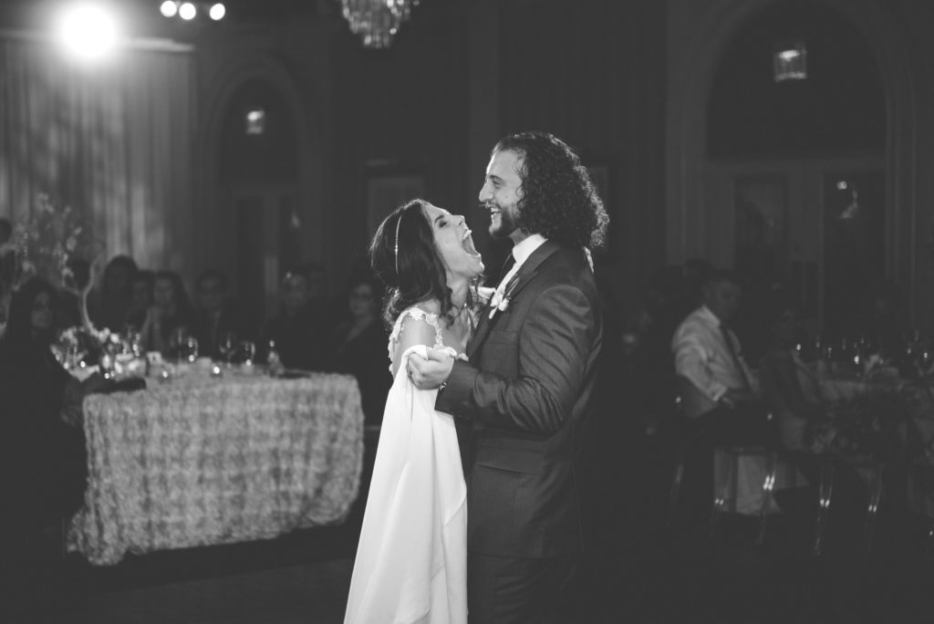 a year in review bride and groom share a laugh during first dance 
