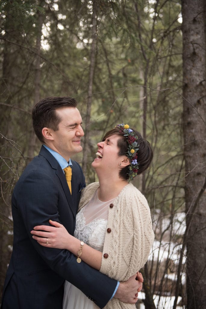 a year in review bride and groom share a laugh outside