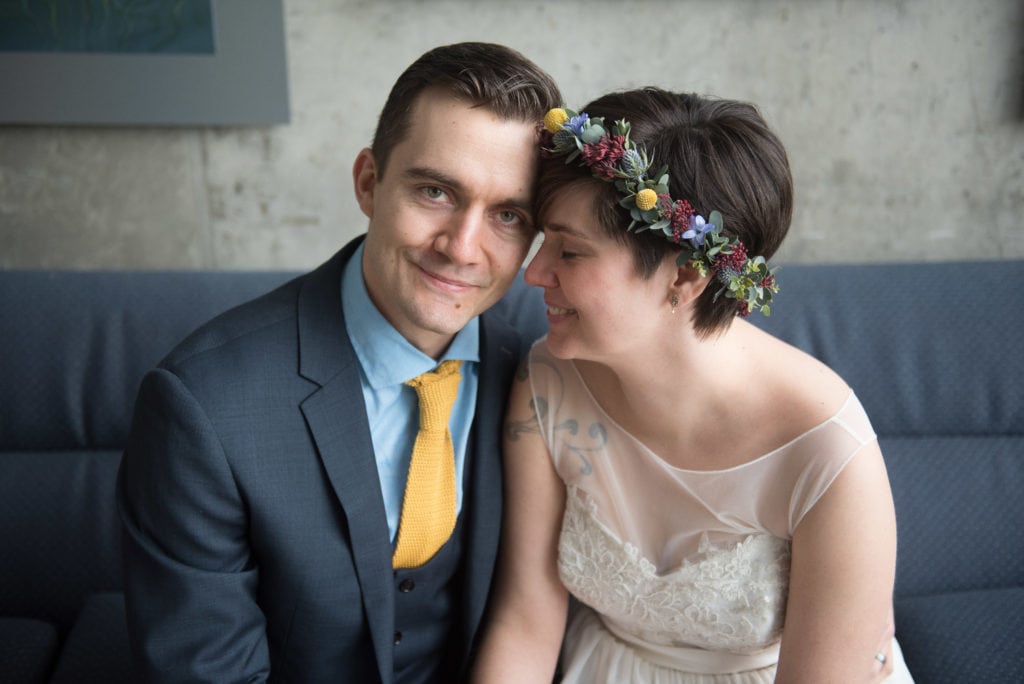 a year in review bride and groom sit on couch and snuggle 