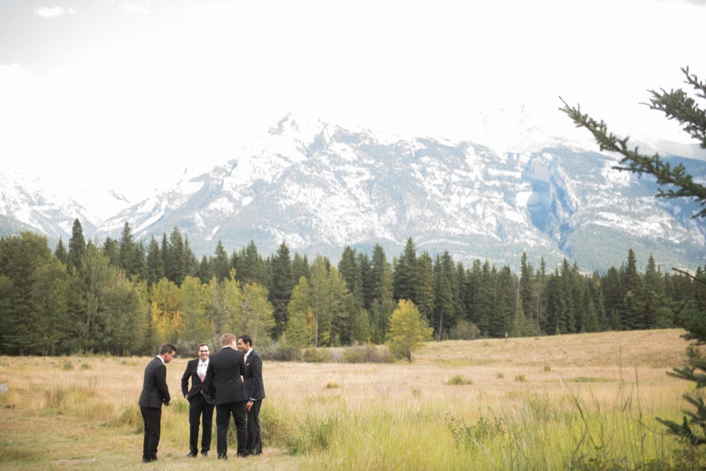 a year in review groomsmen standing in middle of field Canmore