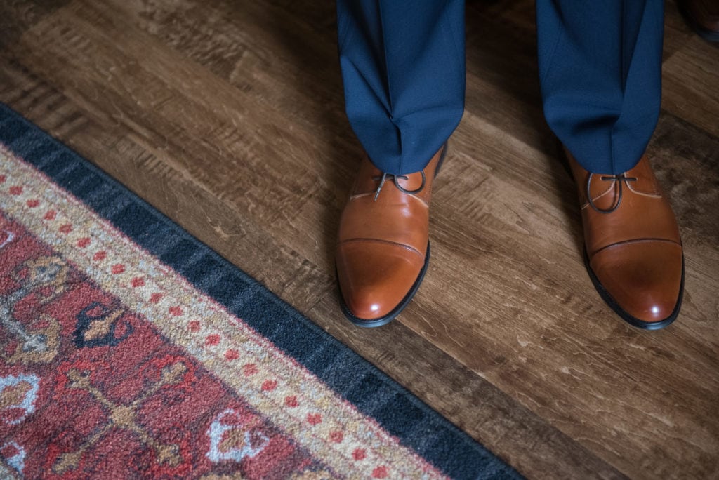 a year in review grooms brown leather shoes next to ornate carpet