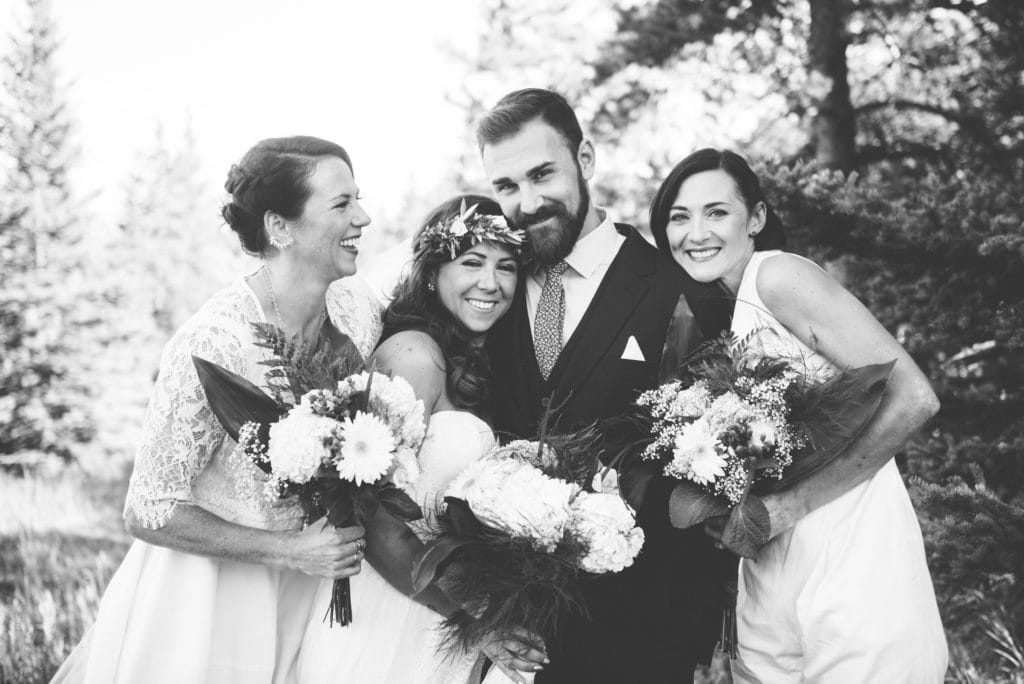 a year in review bride and sisters hug the groom