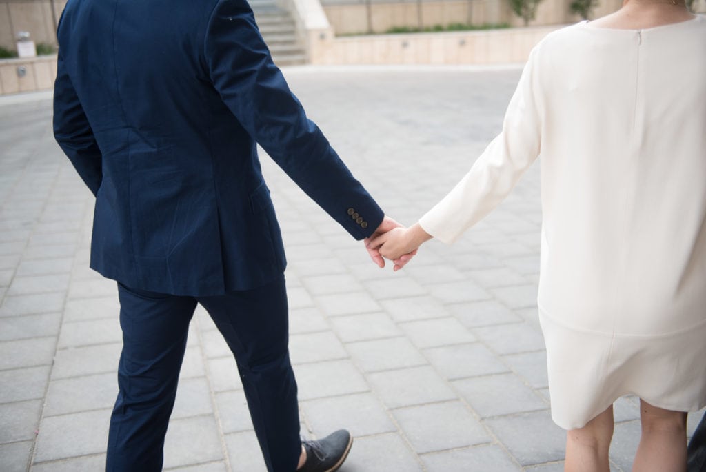 a year in review bride and groom walk hand in hand