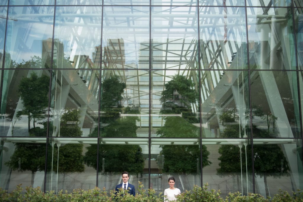 a year in review bride and groom in front of giant glass building 