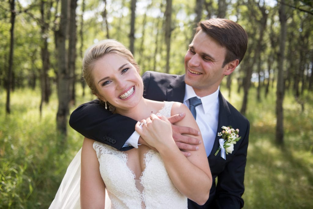 a year in review bride and groom laugh while embracing 