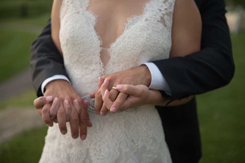 a year in review close up shot of bride and groom hands