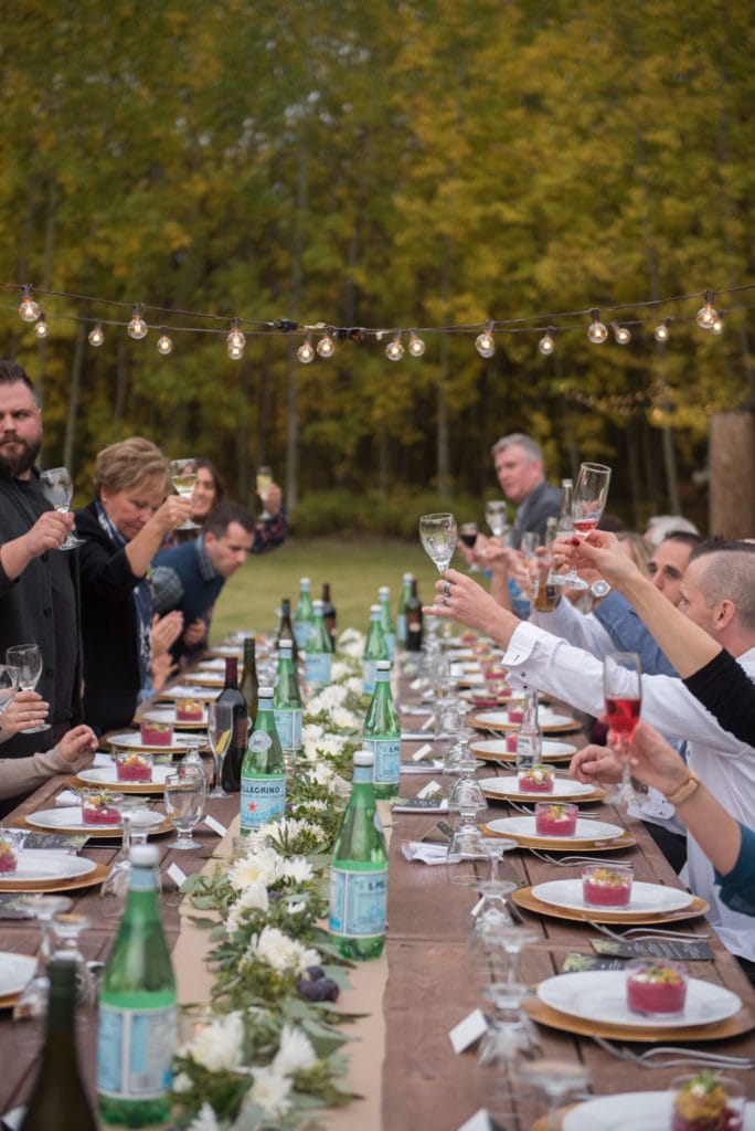 a year in review guests cheer glasses across the table in celebration