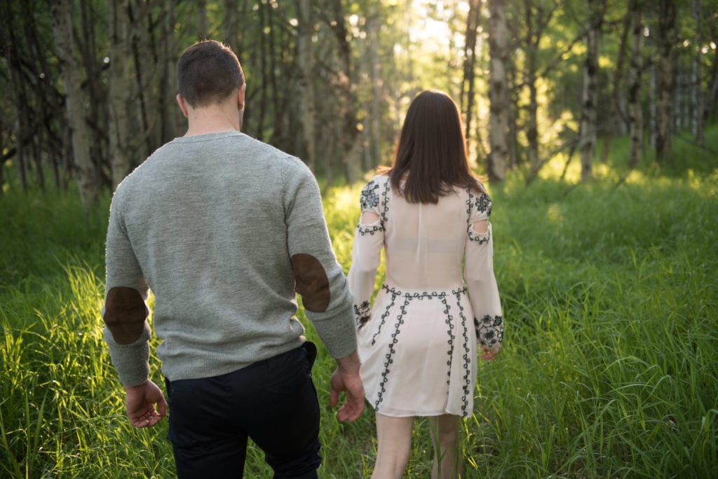 a year in review couple walks through golden lit field