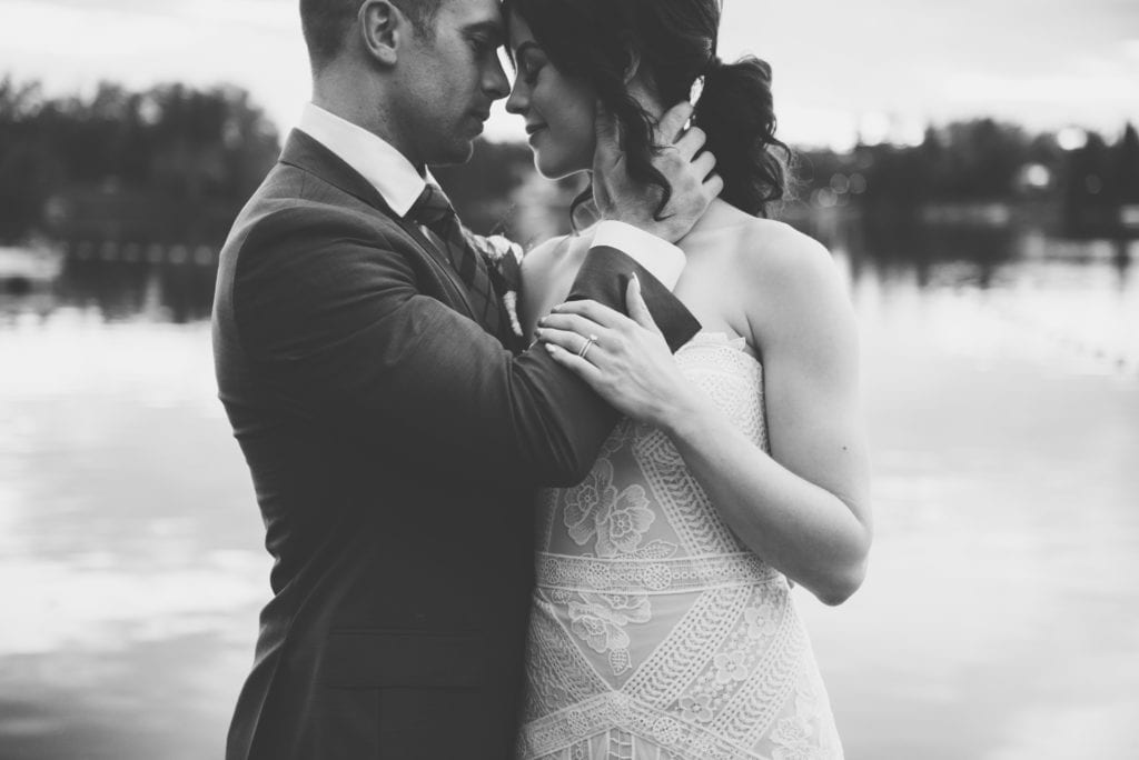 a year in review groom embraces bride on dock 