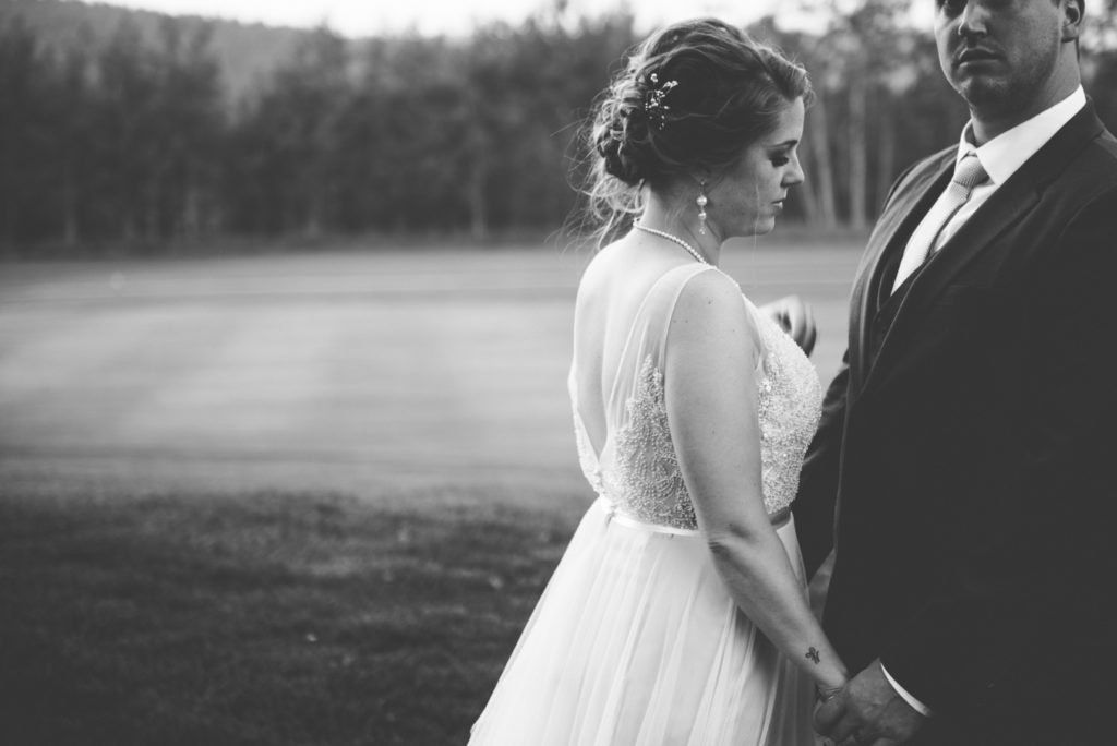 a year in review bride in BHLDN gown leans into groom