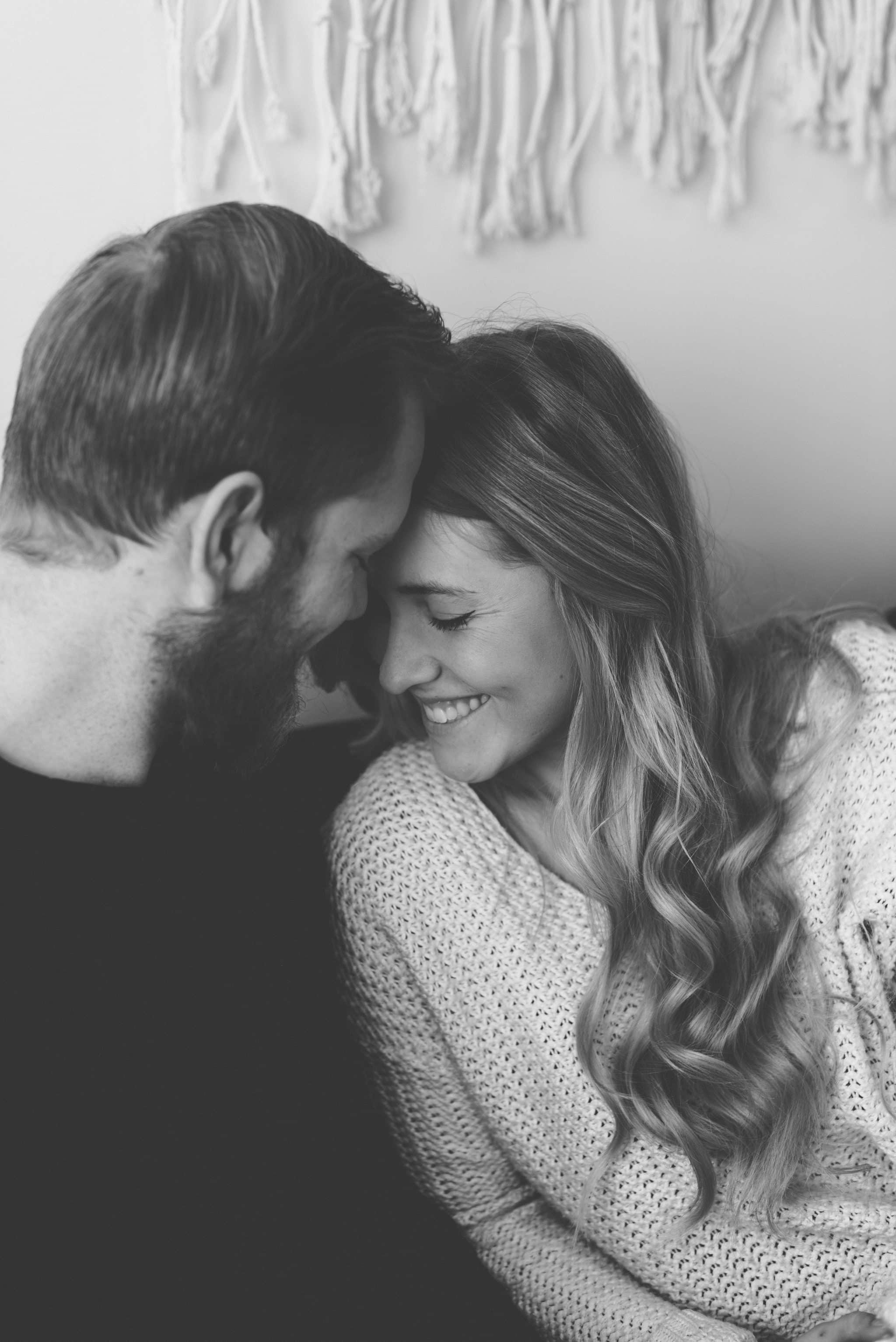 Intimate in home session couple embracing in living room