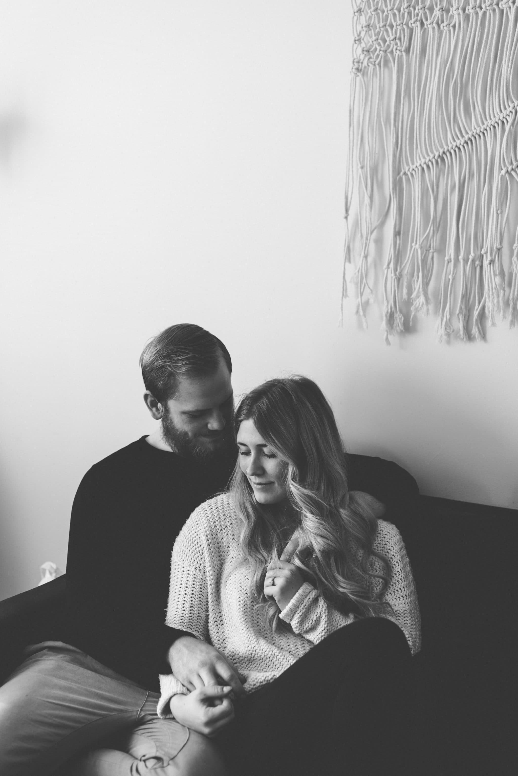 Intimate in home session couple embracing in living room