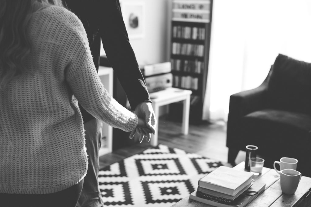 Intimate in home session couple embracing in living room