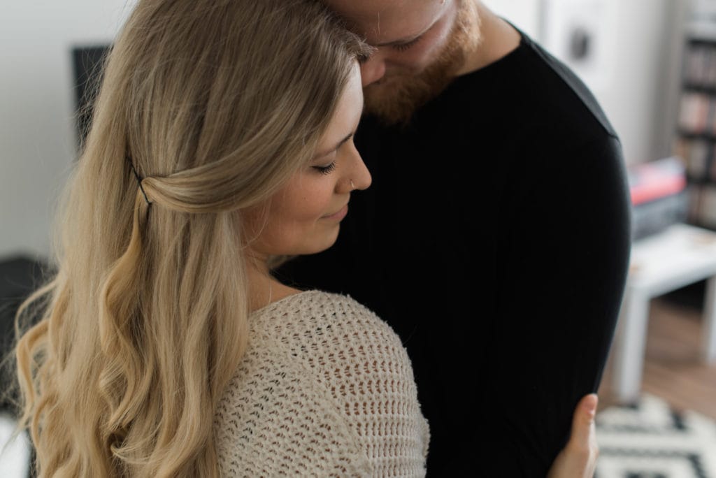 Intimate in home session couple embracing in living room