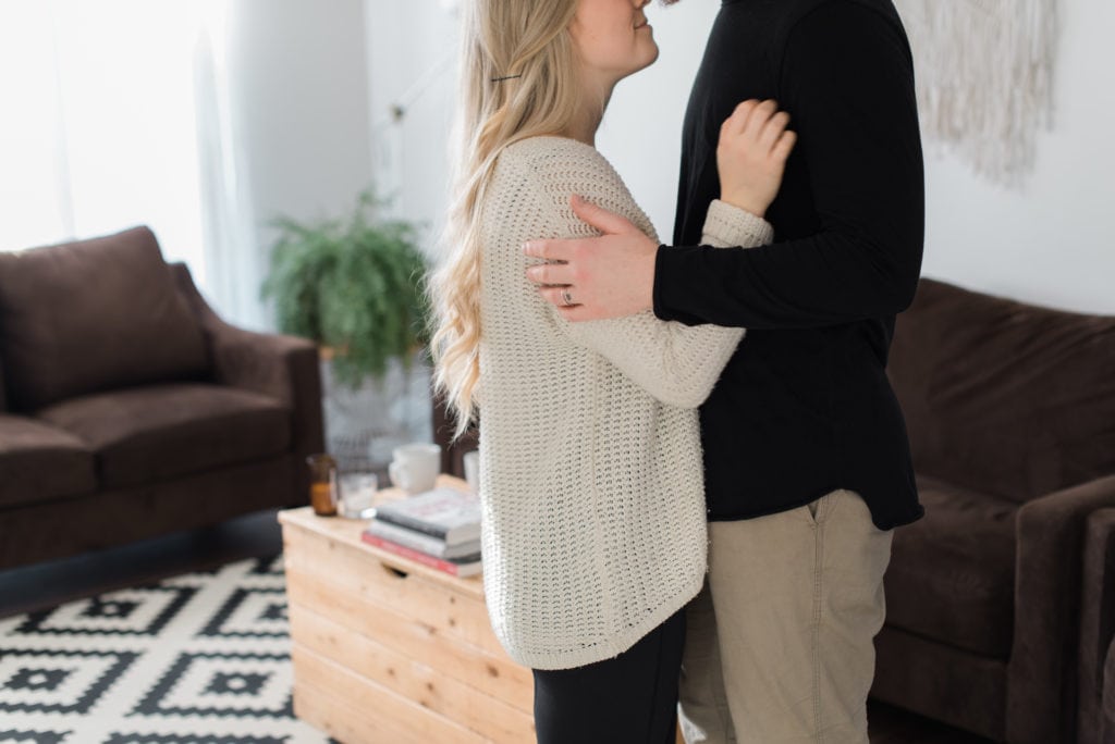 Intimate in home session couple embracing in living room