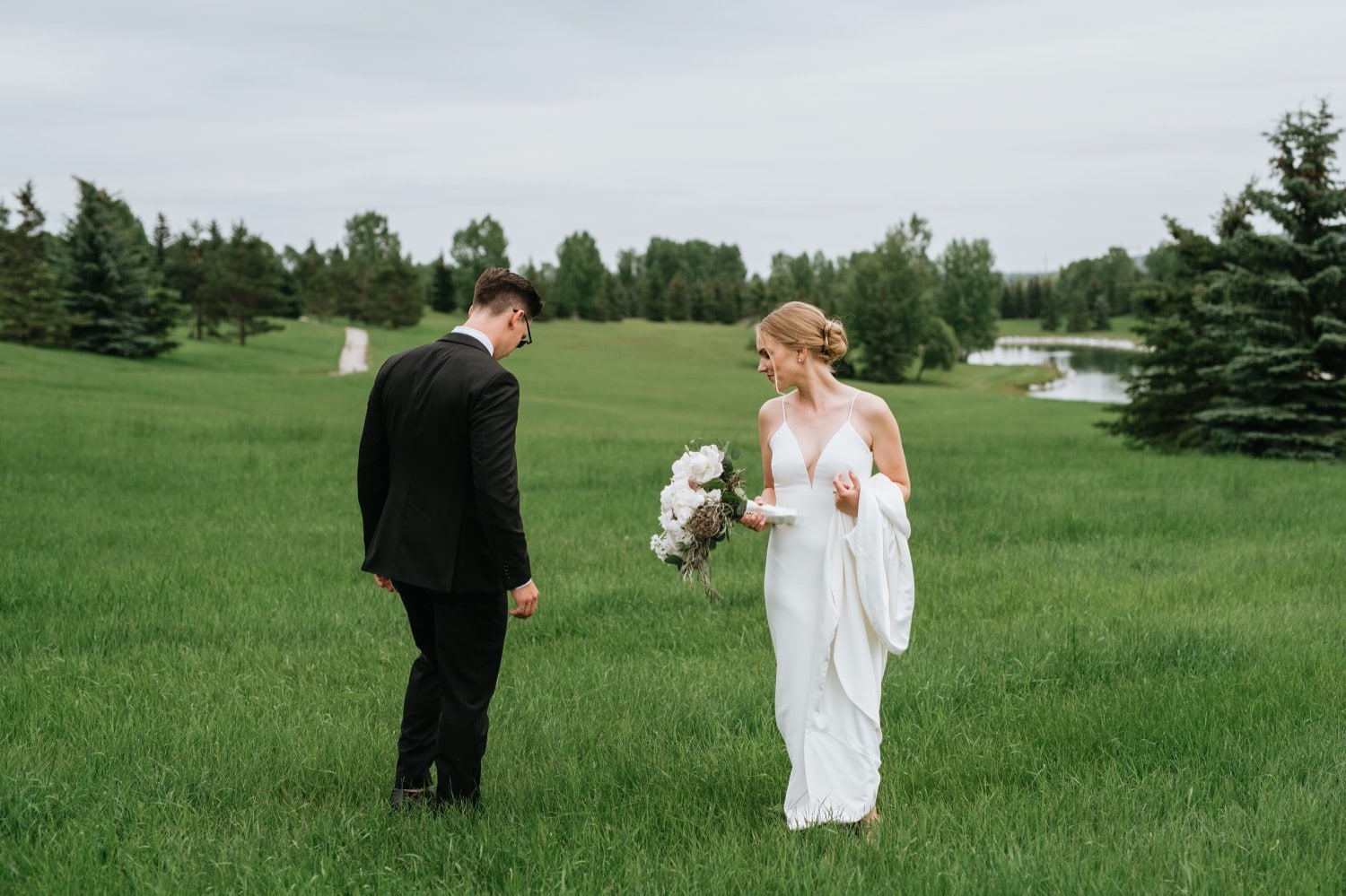 Bride and groom in field 