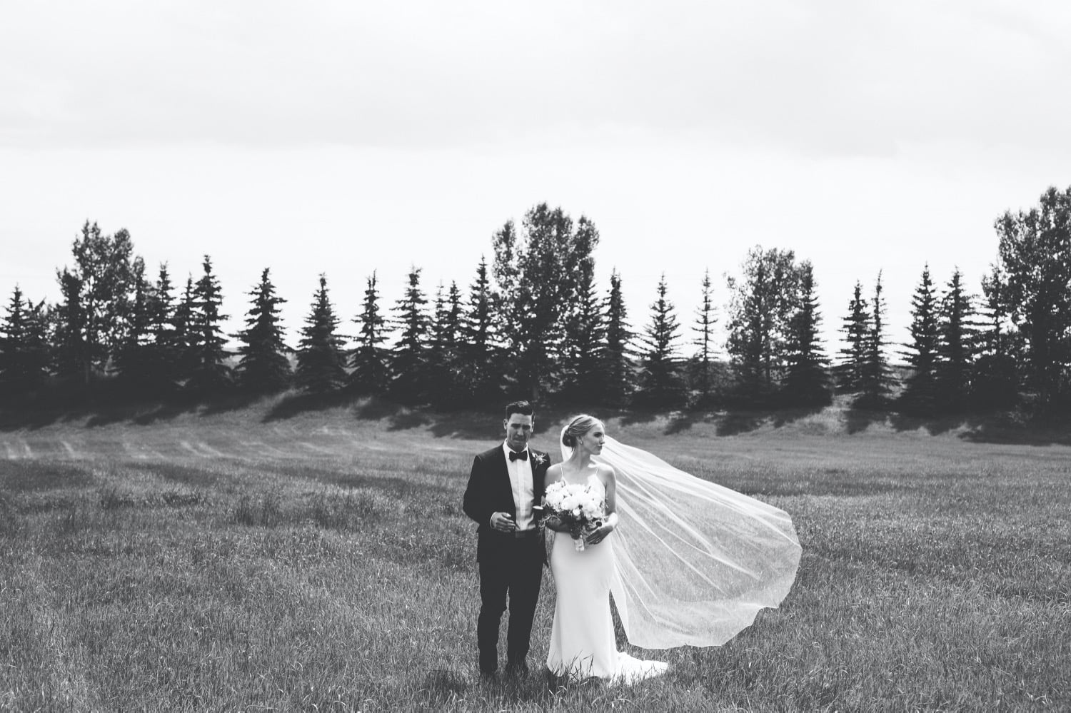 Bride and groom veil blowing in the wind