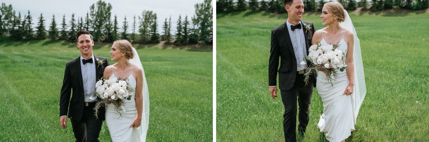 Bride and groom walking through field