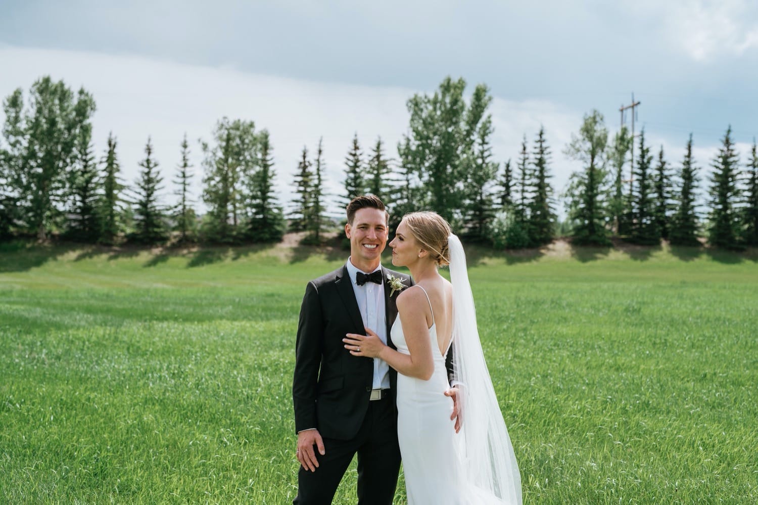 Bride and groom in field