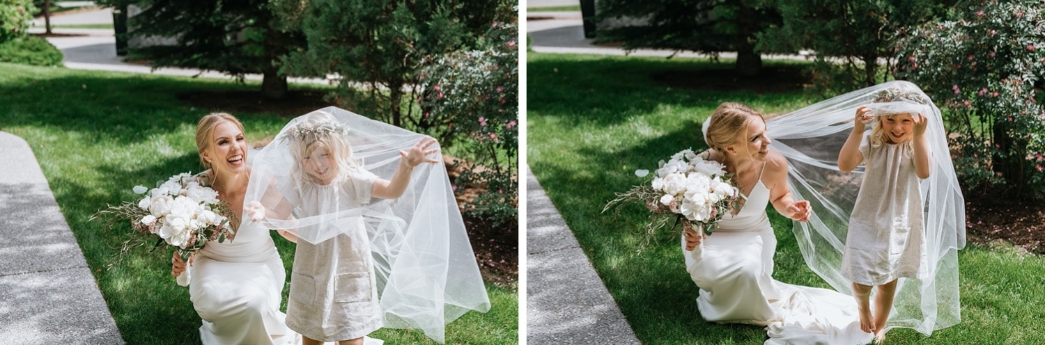 Flowergirl playing with brides veil