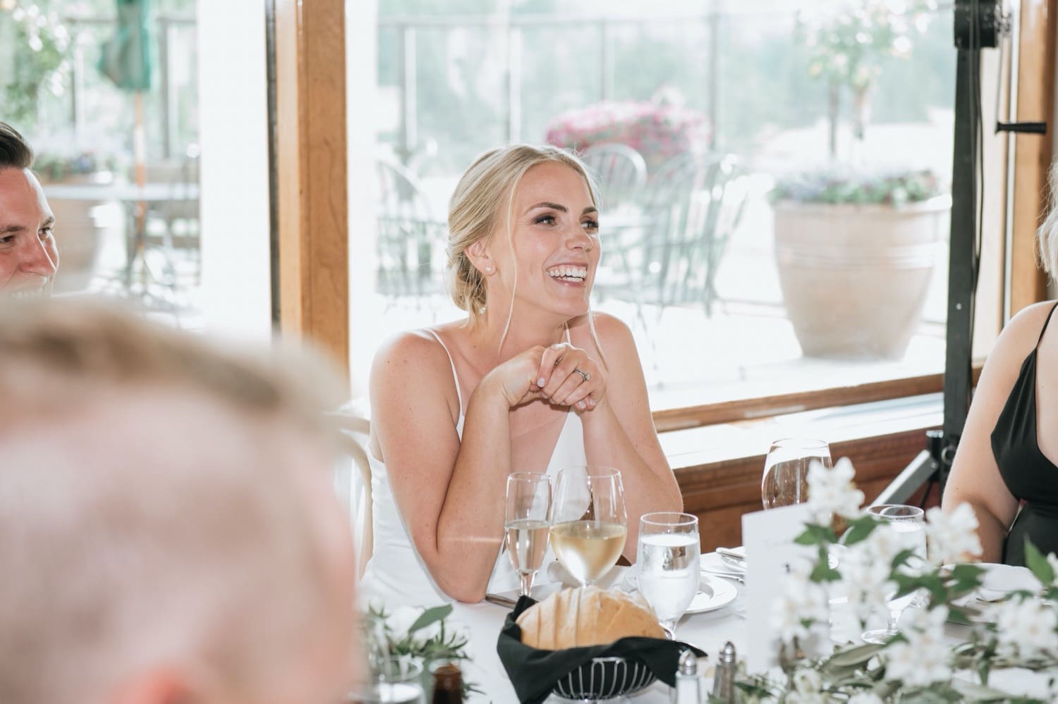 Bride laughing during speeches